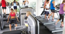 Elevated View Of Busy Gym With People Exercising On Machines